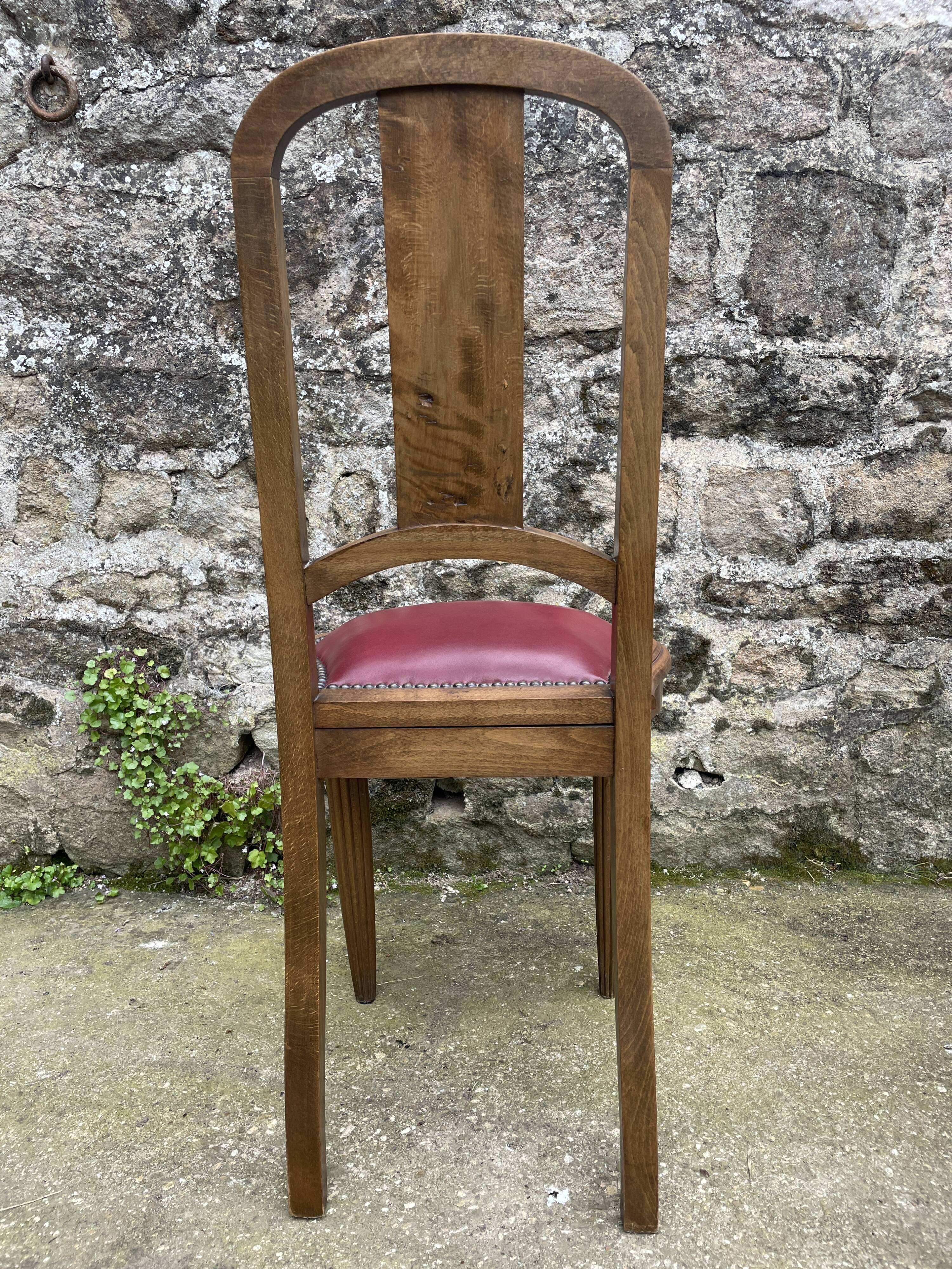 Pair of studded burgundy leather Art Deco chairs