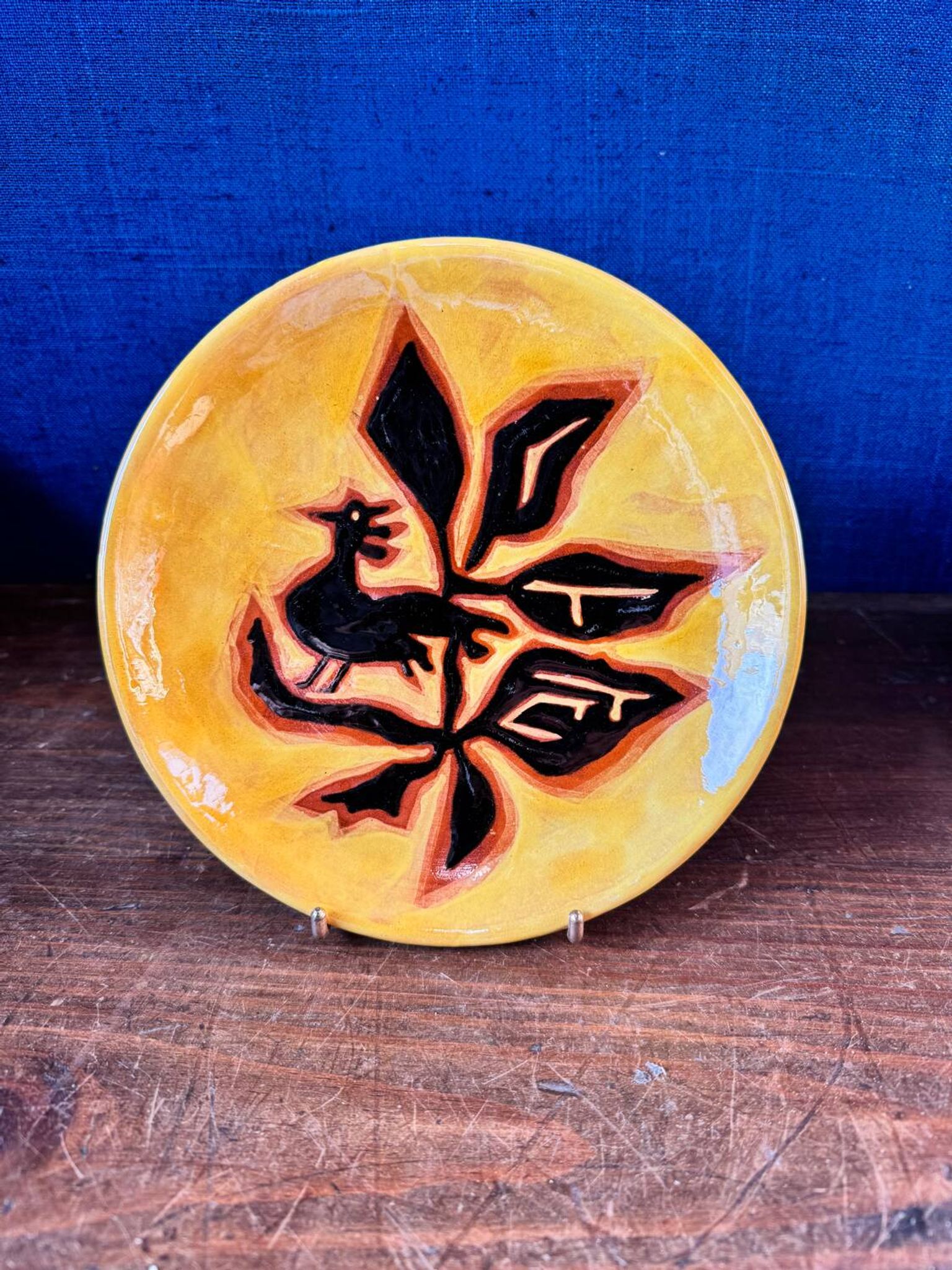 Terracotta plate, Jean Lurçat decorated with a rooster and foliage.