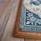 Antique trivet in Gien tile with blue bird decoration – wooden border