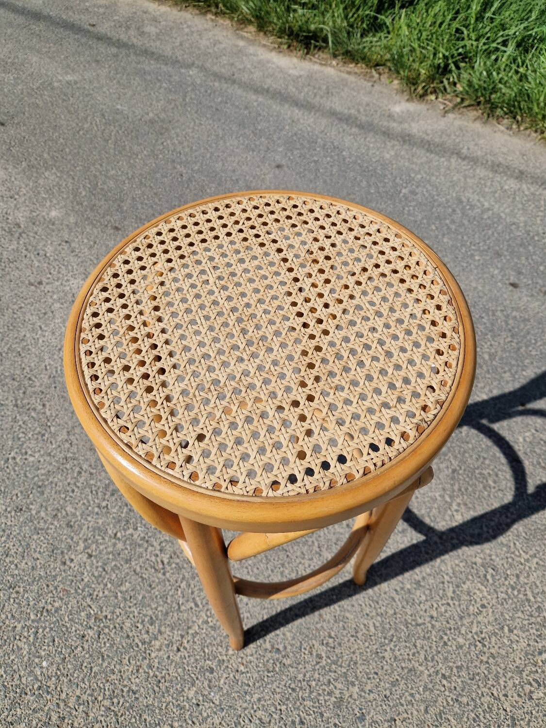 High bar stool in curved wood and cane