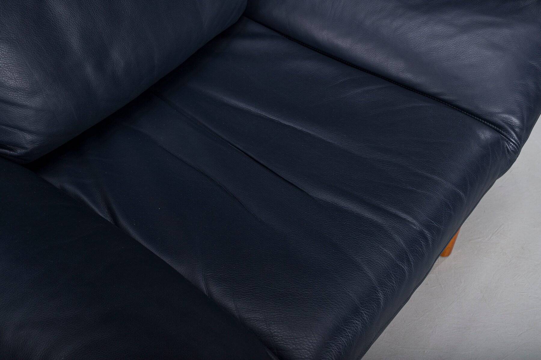 Danish teak and navy blue leather lounge chair from Komfort, 1970s