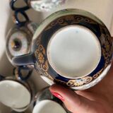 CHINA, 20th century Part of a porcelain tea service with polychrome decoration of palace scenes and v