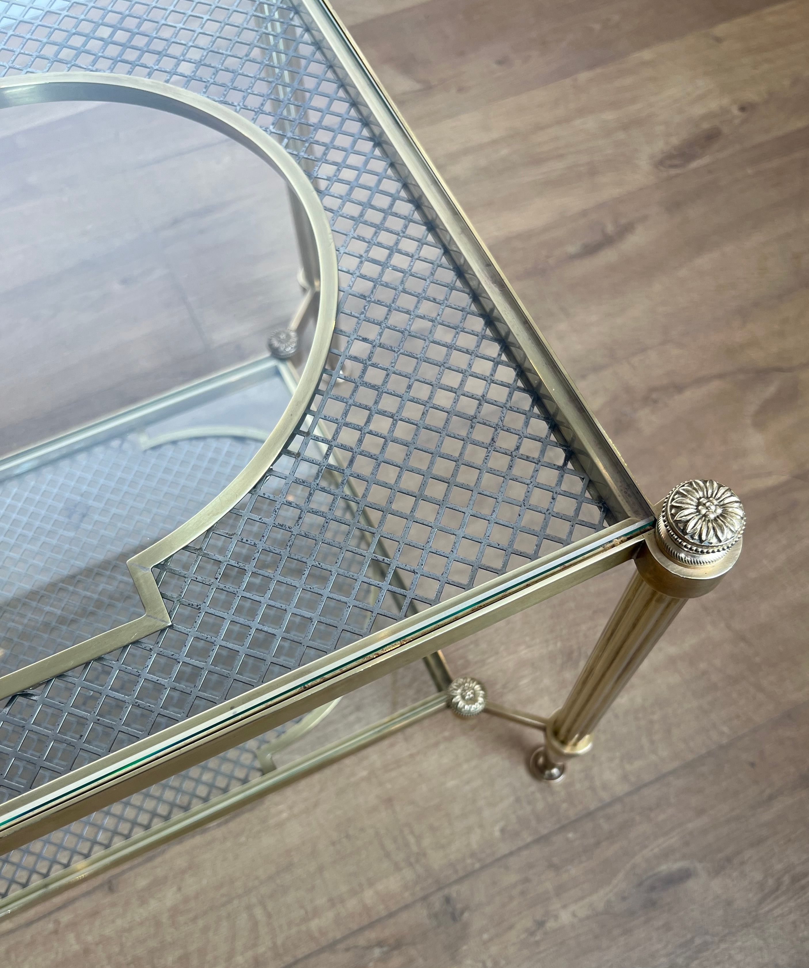 Rare bronze, brass, and steel mesh coffee table with a double glass top resting on a brass mesh. French work by Jansen