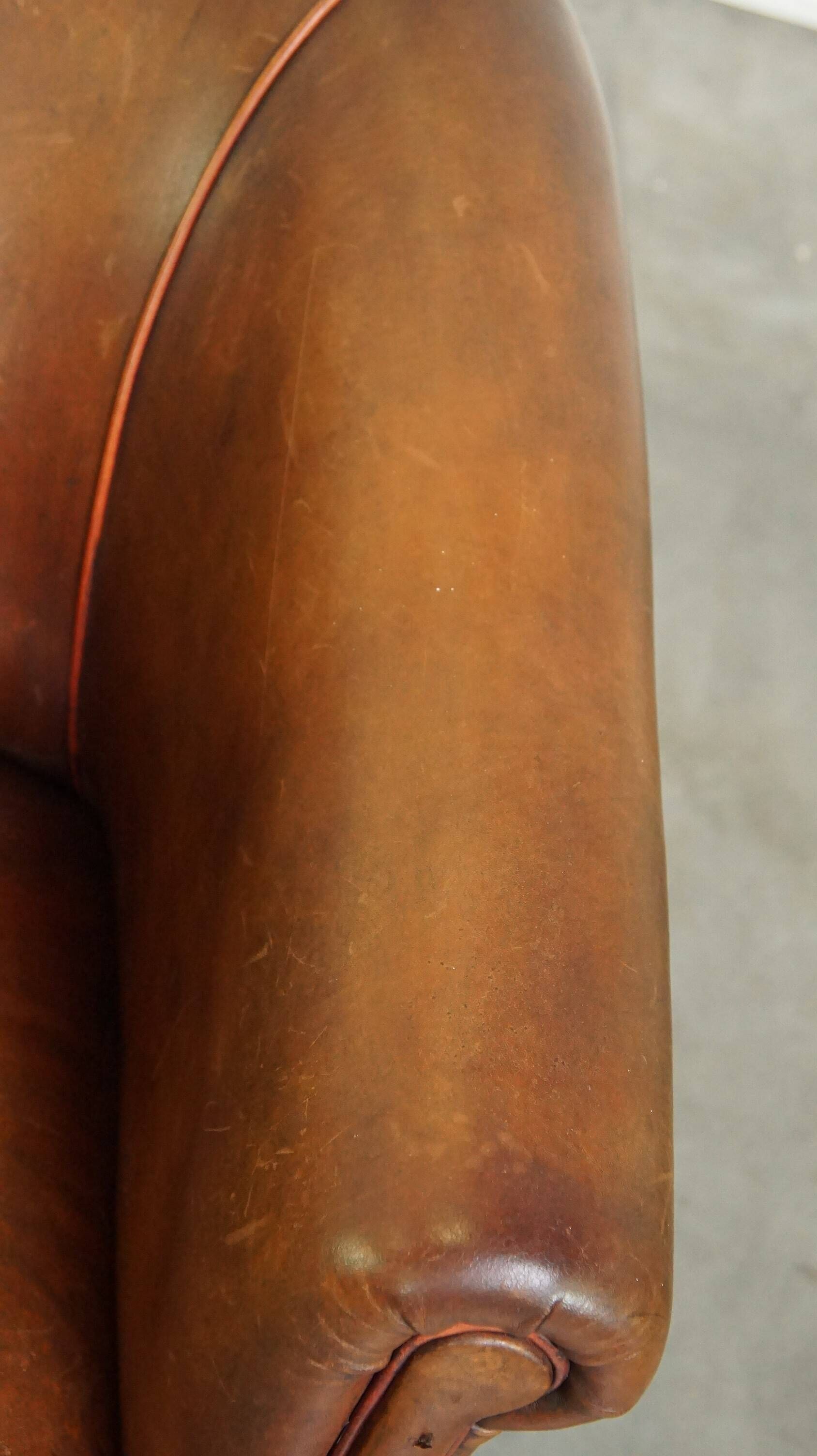 Neat, elegantly finished, cozy sheepskin club armchair with a fixed seat cushion