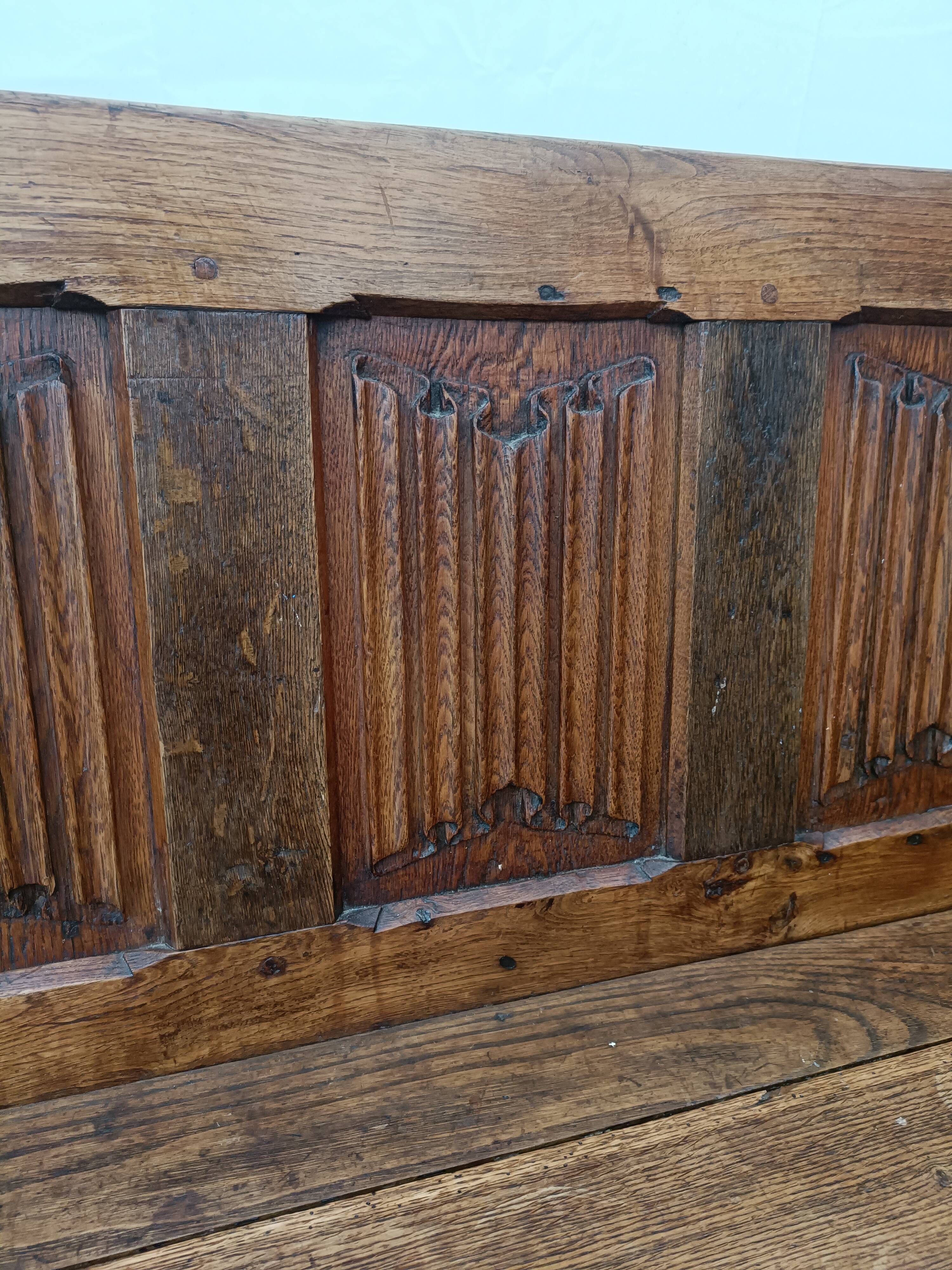 Oak church bench period XVII th century, back decorated with carved parchments