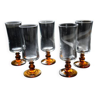 Amber stemmed champagne glasses
