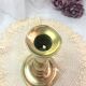 Gilded copper push candle holder