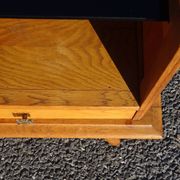 Vintage oak bedside table with tapered legs.