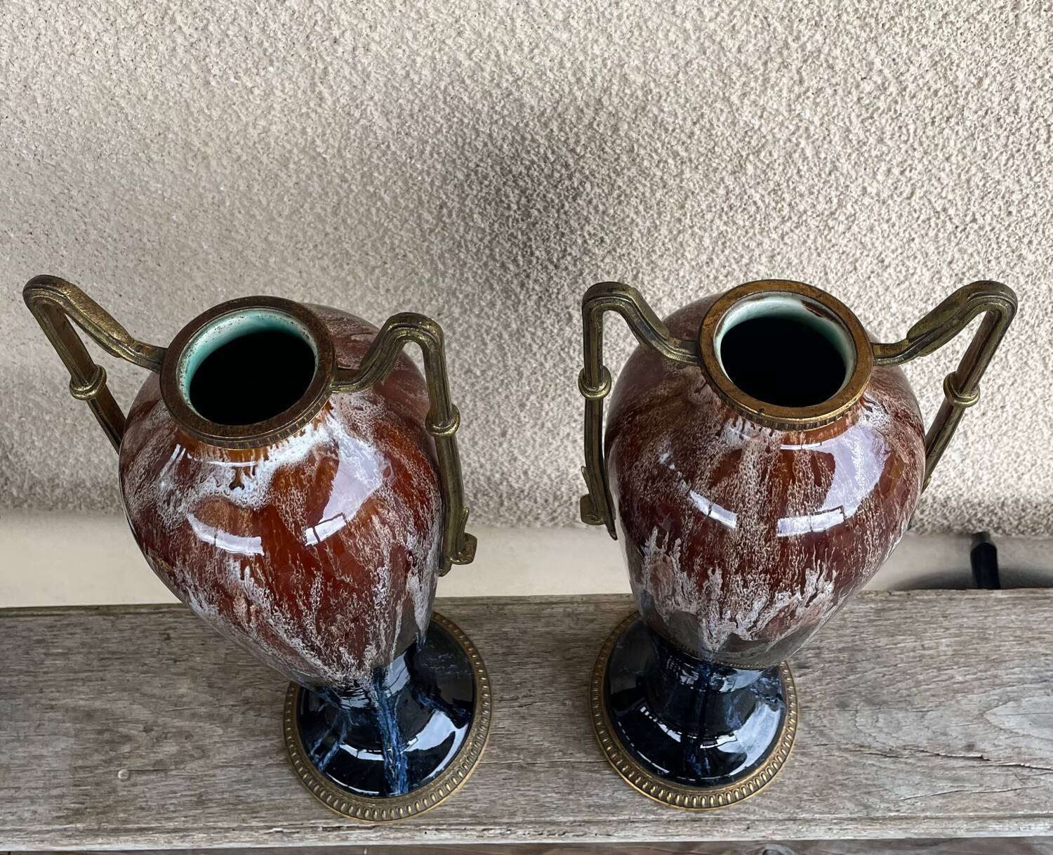 Two large stoneware vases with bronze fittings.