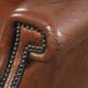 Sheepskin wingback armchair finished with black piping and a correct seat