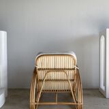 Large rattan rest chair and white cushions