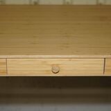 Small bamboo desk with three drawers.