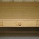 Small bamboo desk with three drawers.