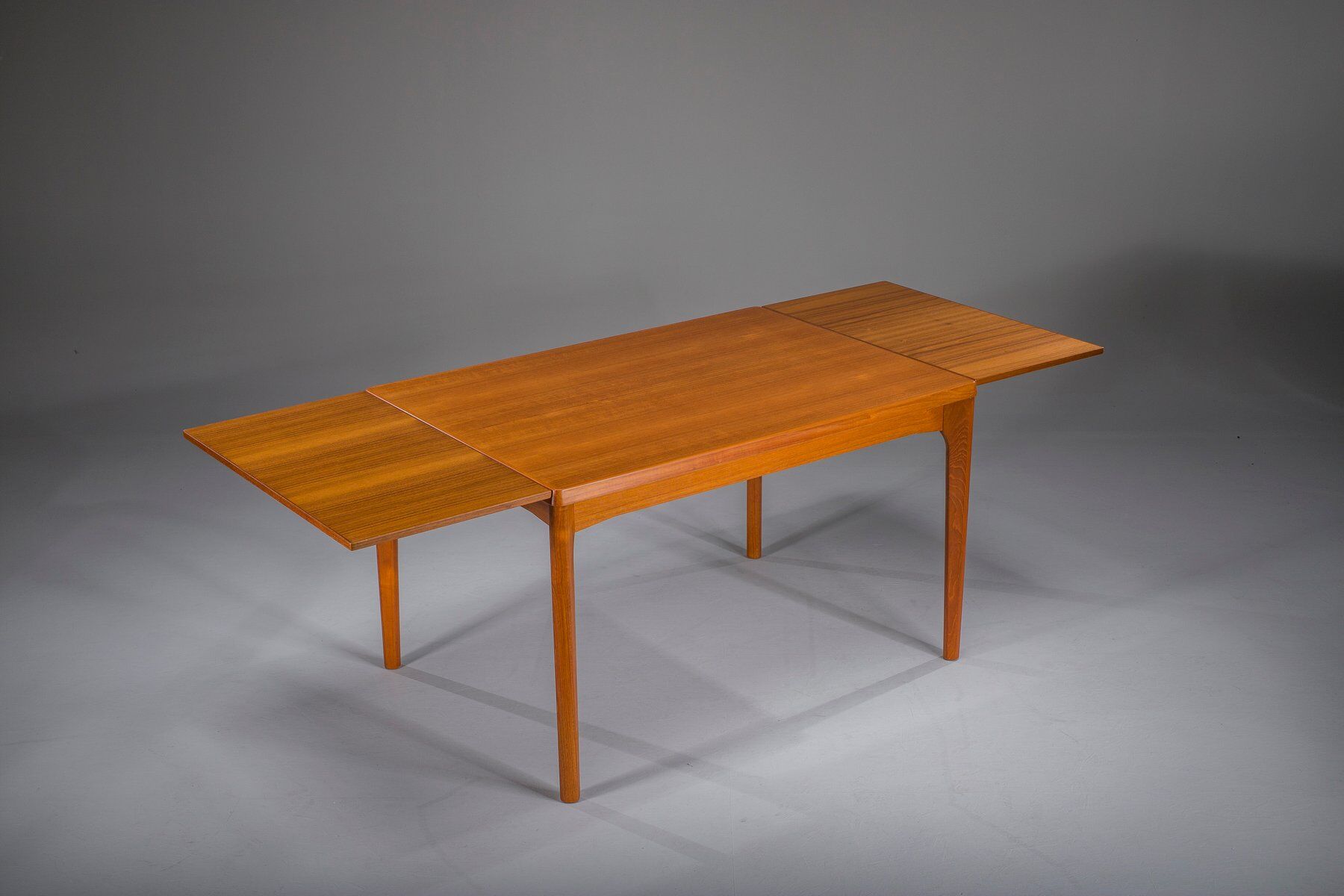Extendable teak dining table by Henning Kjaernulf for Vejle Stole & Møbelfabrik