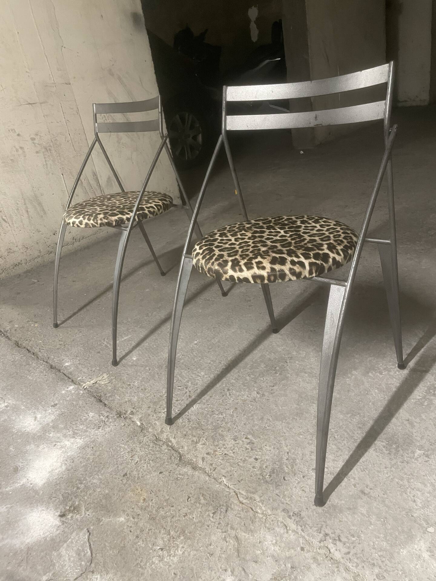 Pair of folding chairs from the 80s with leopard print seats.