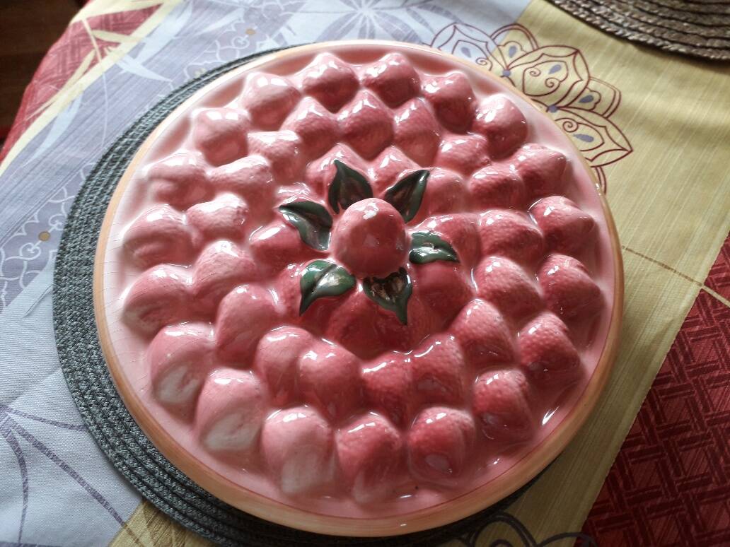 Glazed ceramic dessert plate with strawberry design.
