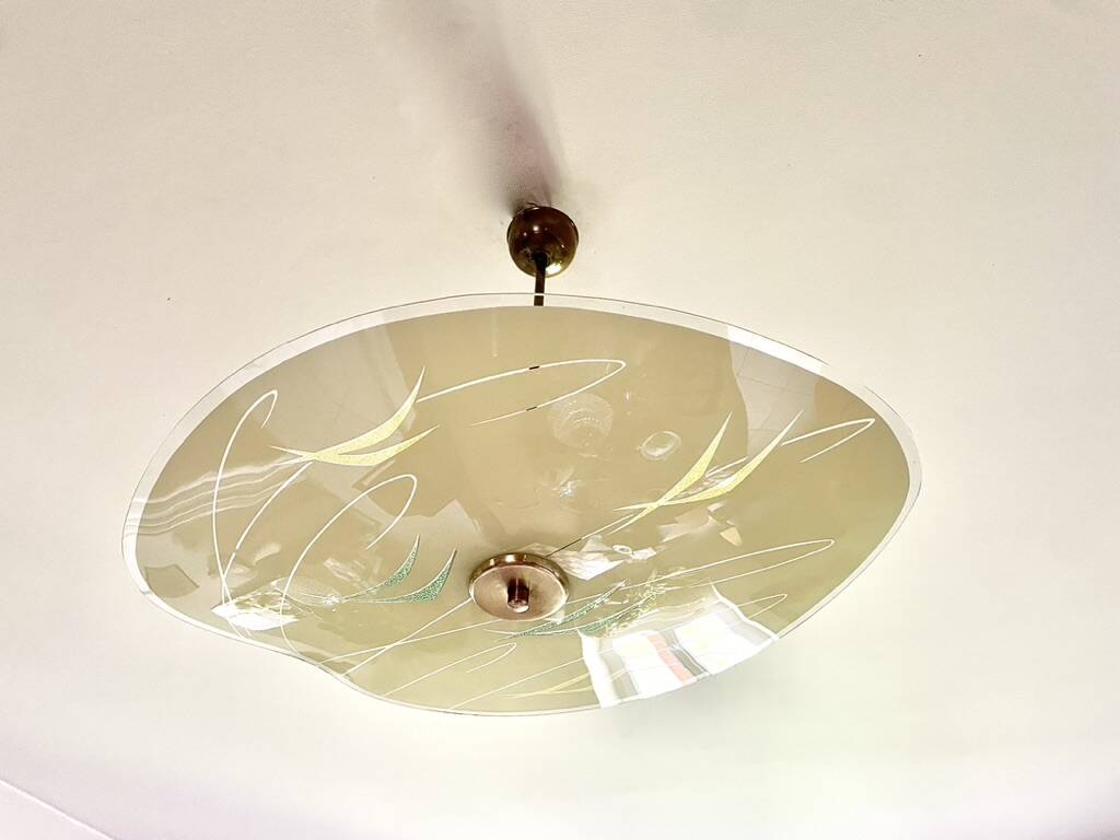 Pale yellow asymmetrical suspension cup 1960