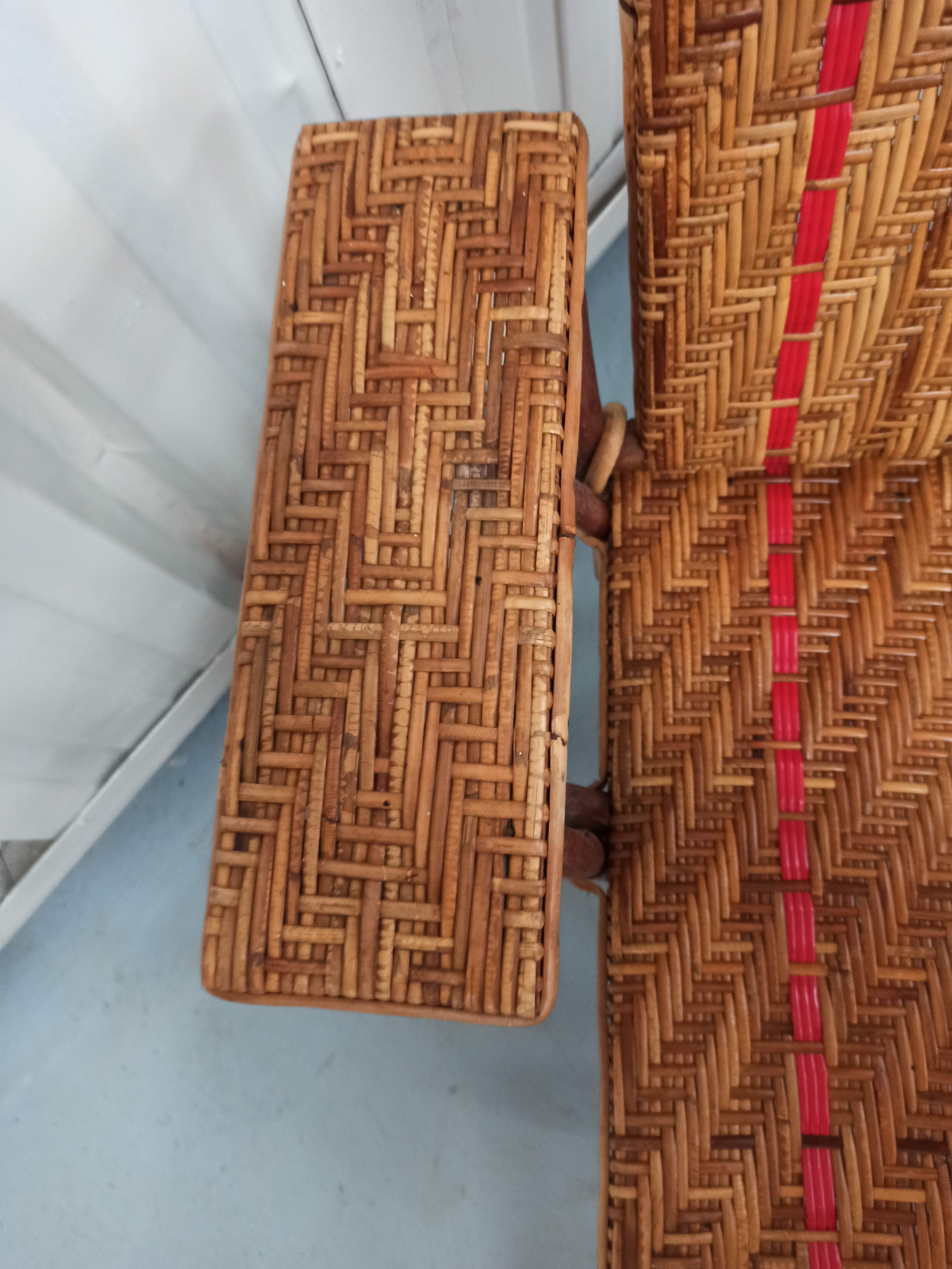 Sunbathing sunbathing in wicker rattan wood deckchair red lounger