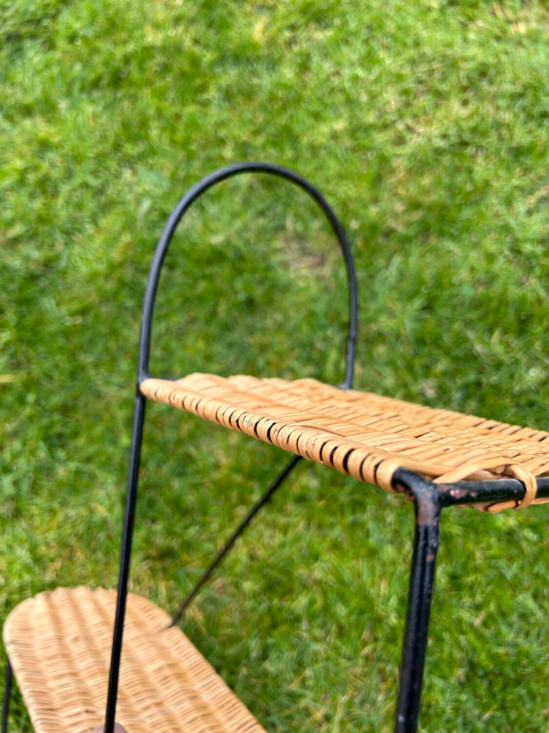 Wall shelf made of rattan and wrought iron