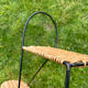 Wall shelf made of rattan and wrought iron
