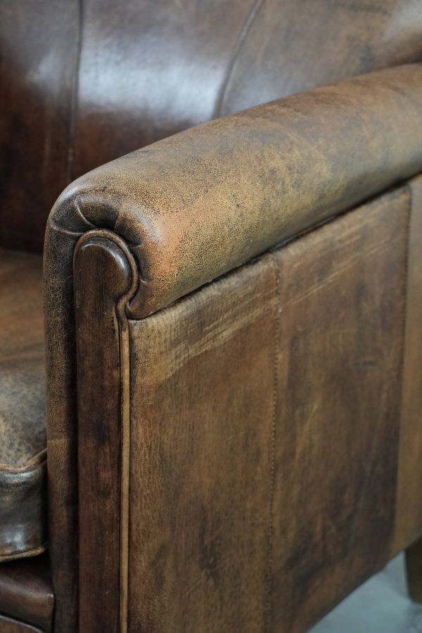 Beautiful vintage sheep leather armchair with a characterful appearance