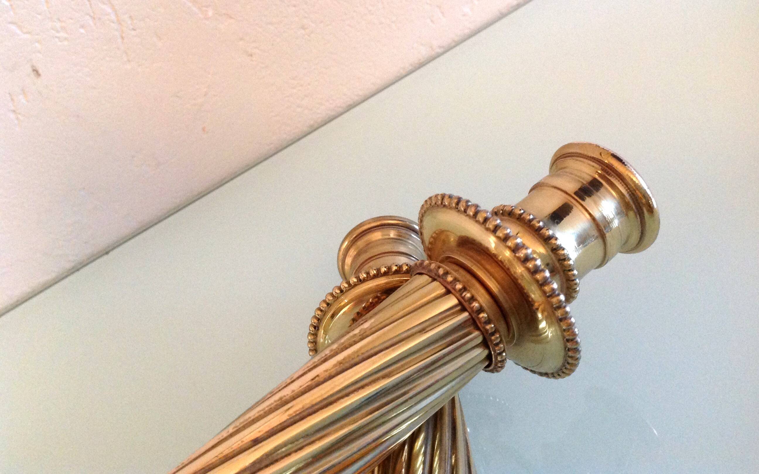 Pair of empire style brass candlesticks