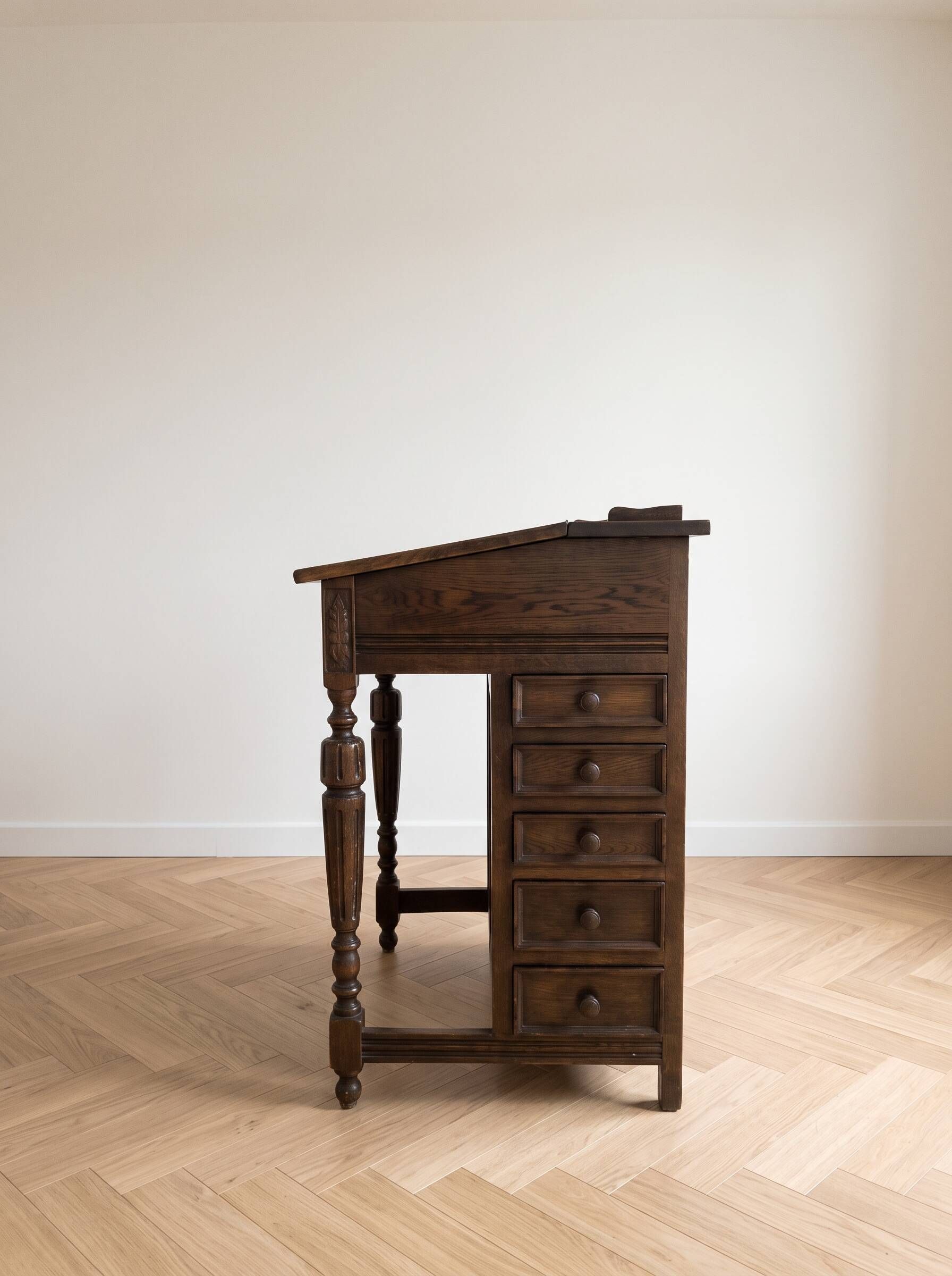 Antique wooden desk with a leather top.