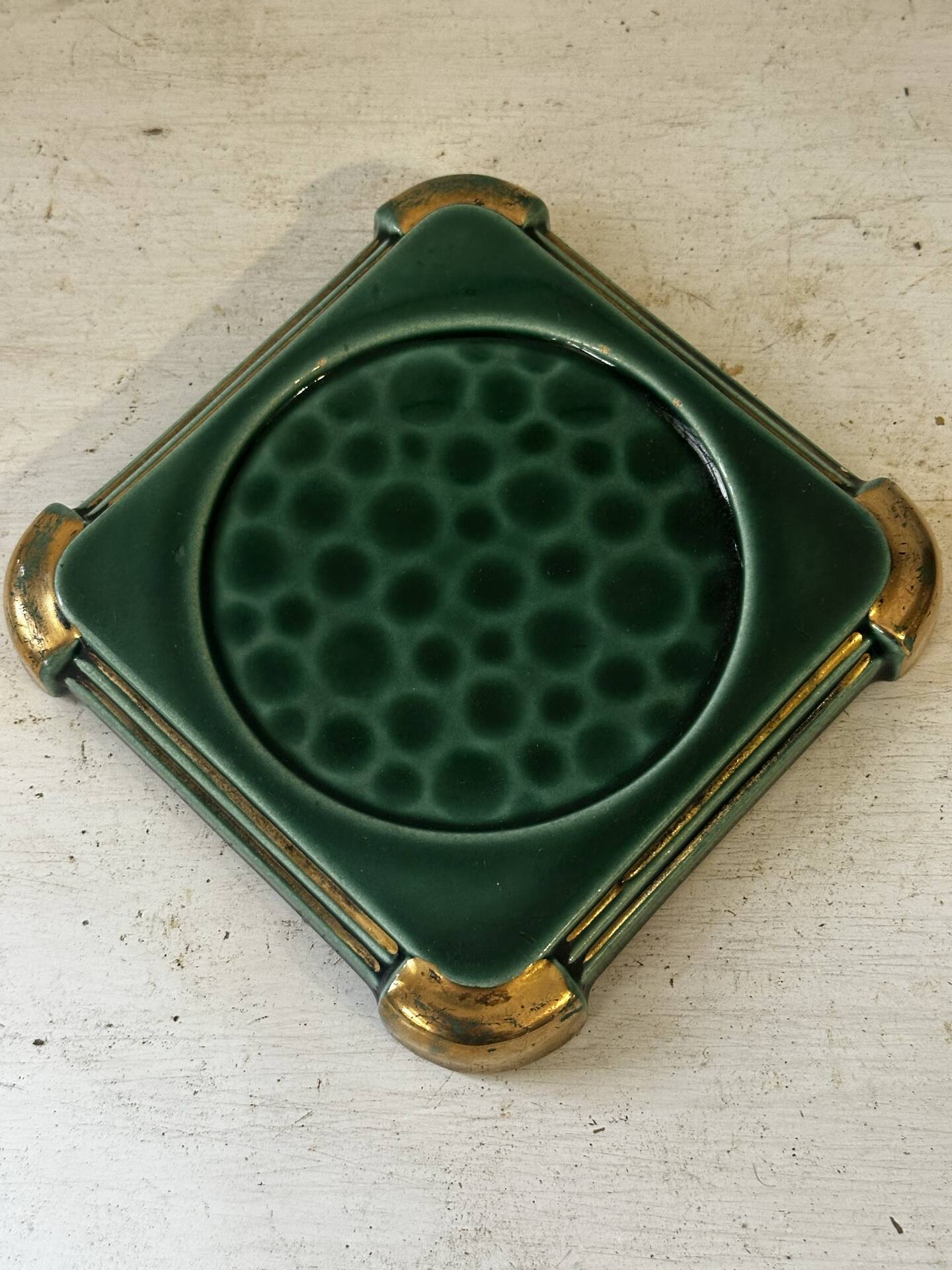 Art Deco bottle coaster in speckled green glazed ceramic and
