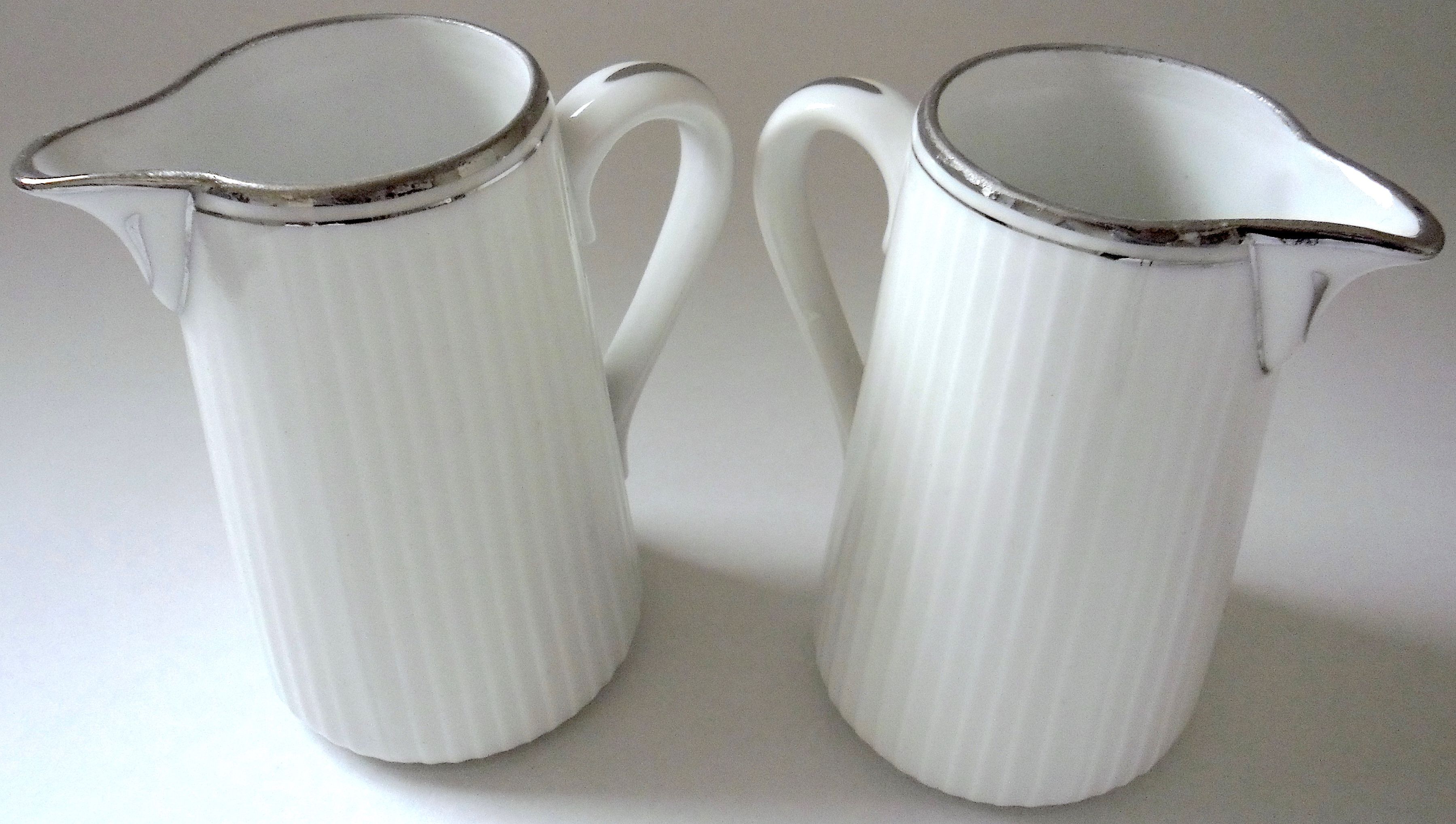 Pair of creamers in white porcelain enhanced with platinum