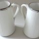 Pair of creamers in white porcelain enhanced with platinum