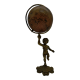 Cherub or putti carrying a globe