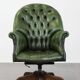 Large Chesterfield office armchair in green cowhide, in English style, on wheels.