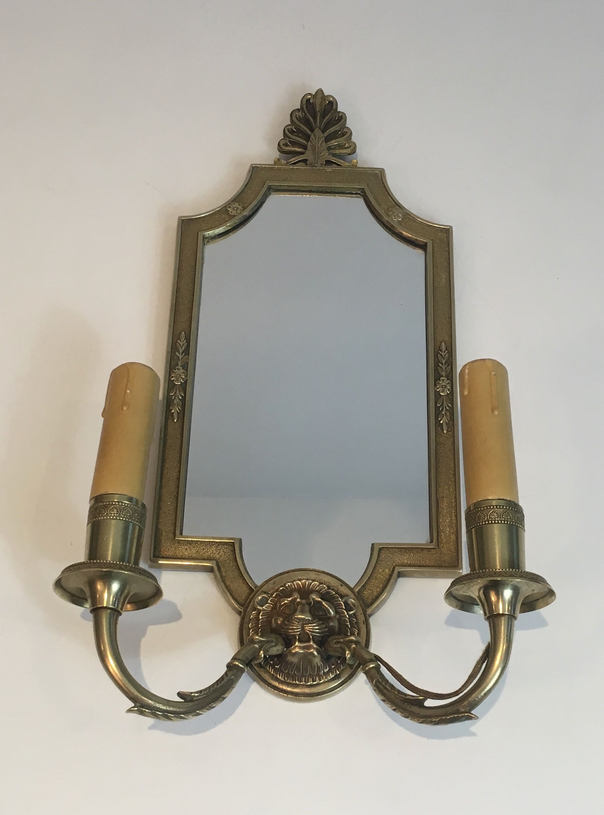 Pair of mirror and bronze wall lamps with lions' heads, french work. around 1940