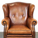 Sheepskin leather wingback armchair, with nails and black piping