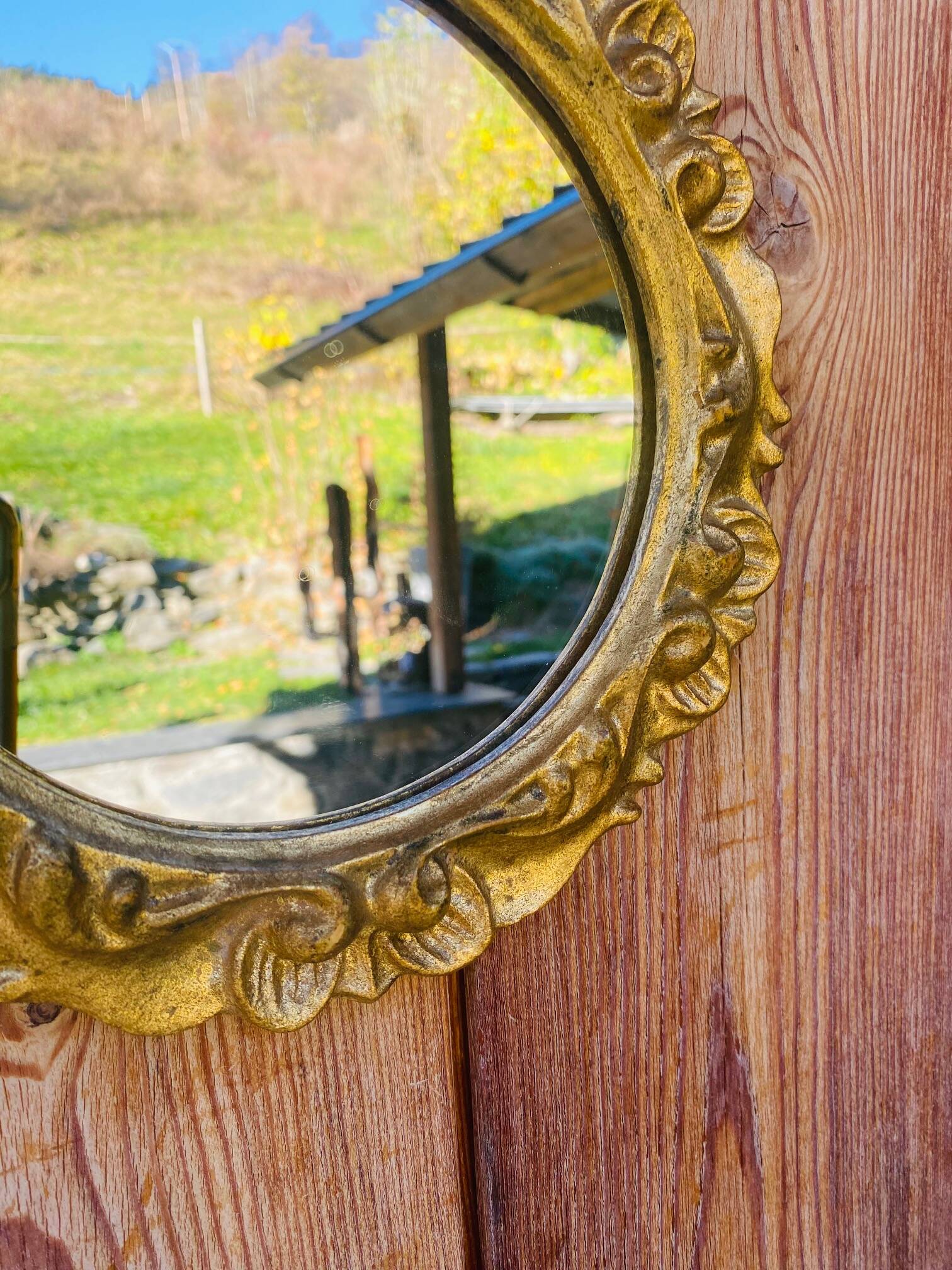 Small round antique gold mirror