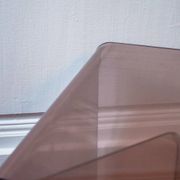 Vintage trio of nesting tables in smoked plexiglass by Michel Dumas, year.
