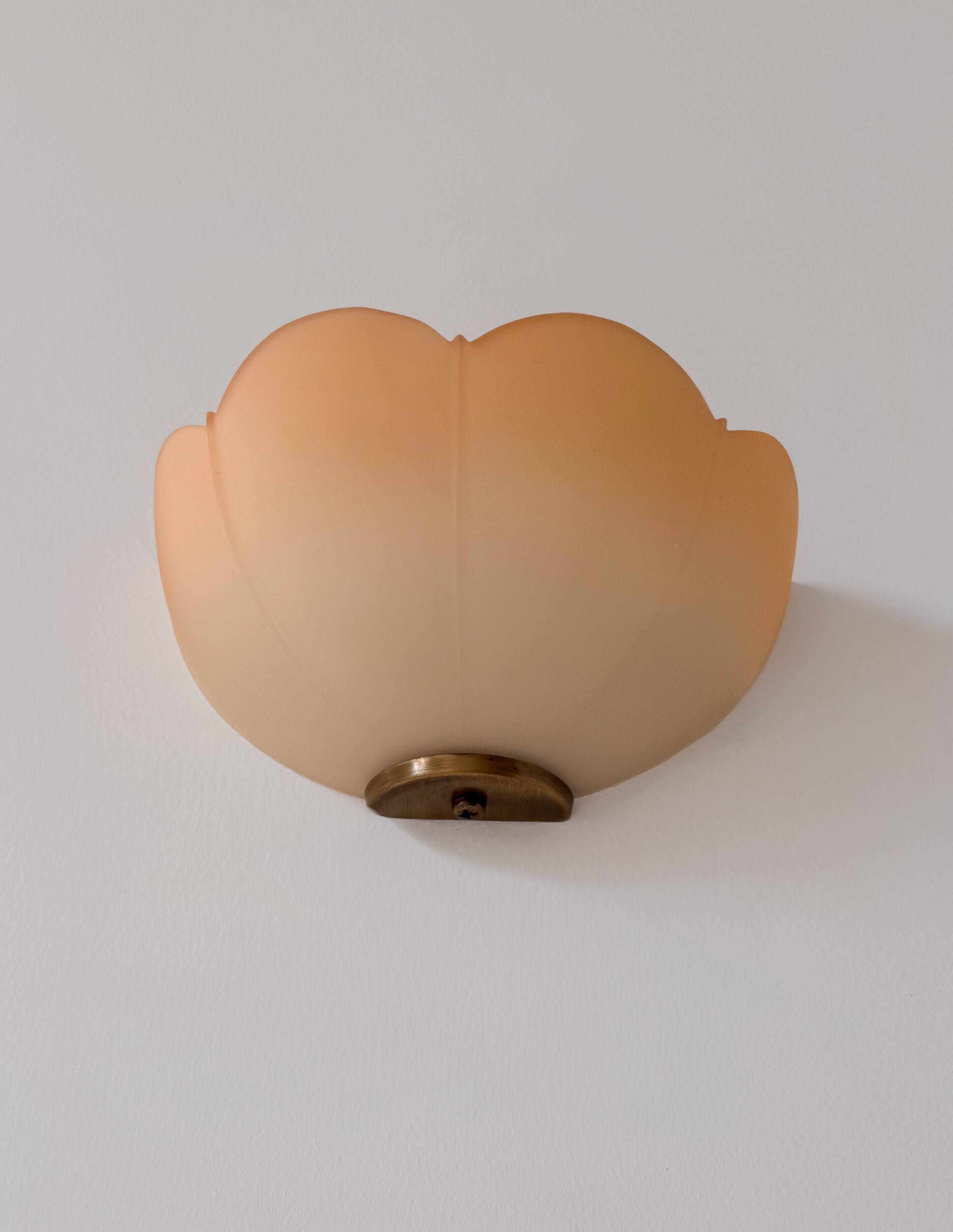 Vintage brass and orange glass wall lights, France 1970.