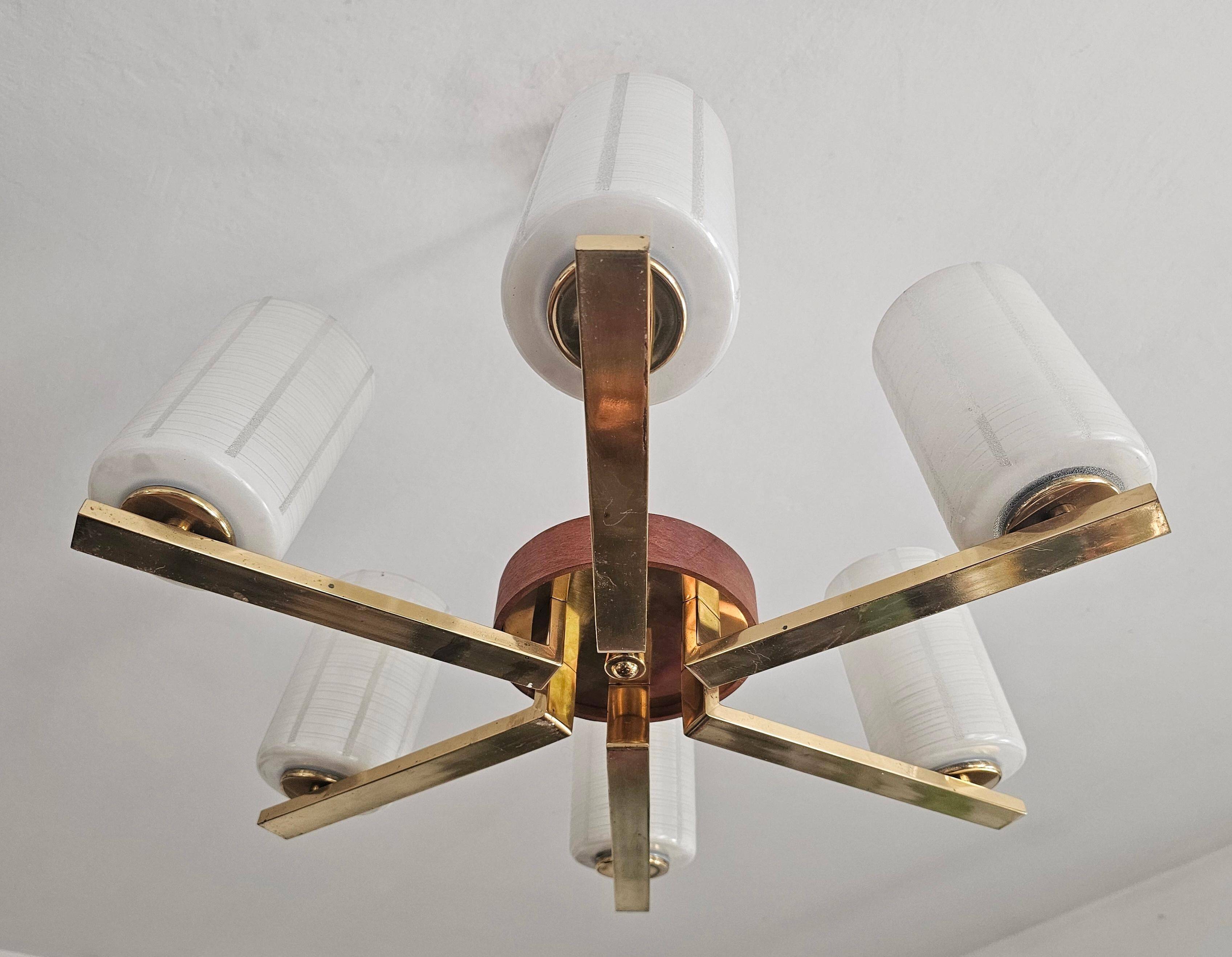 Lustre Mid Century Modern with 6 brass arms, teak, and frosted glass.