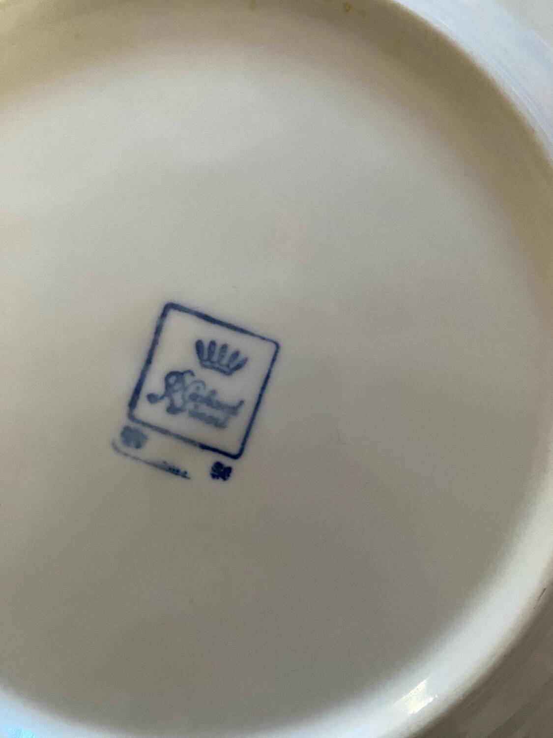 5 mismatched old white plates.