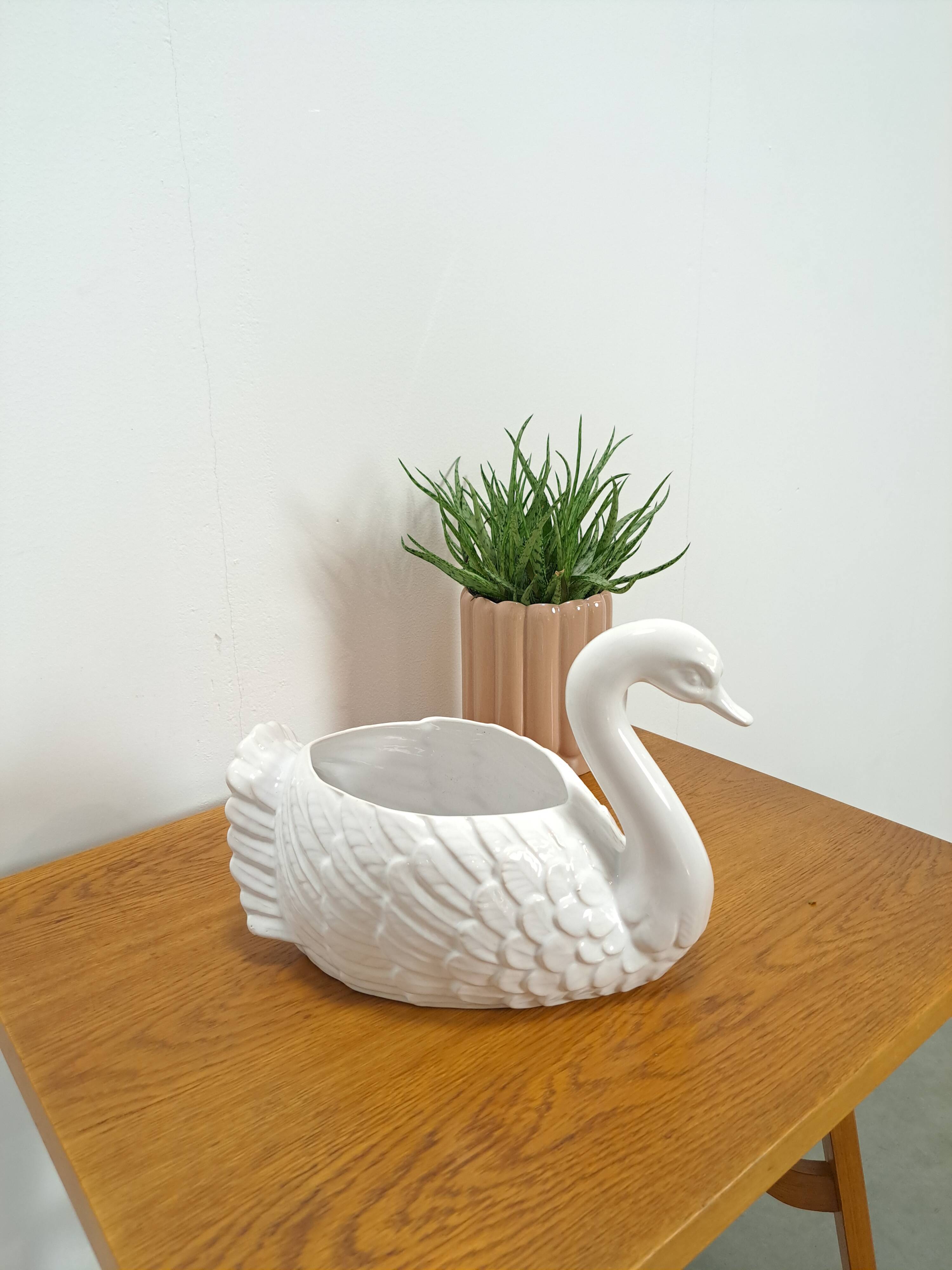vintage porcelain flower pot in the shape of a swan