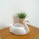 vintage porcelain flower pot in the shape of a swan