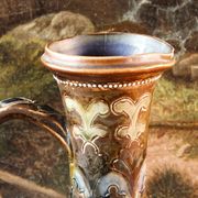 Doulton Lambeth stoneware jug (1879), floral decoration by Henry Winstanley.