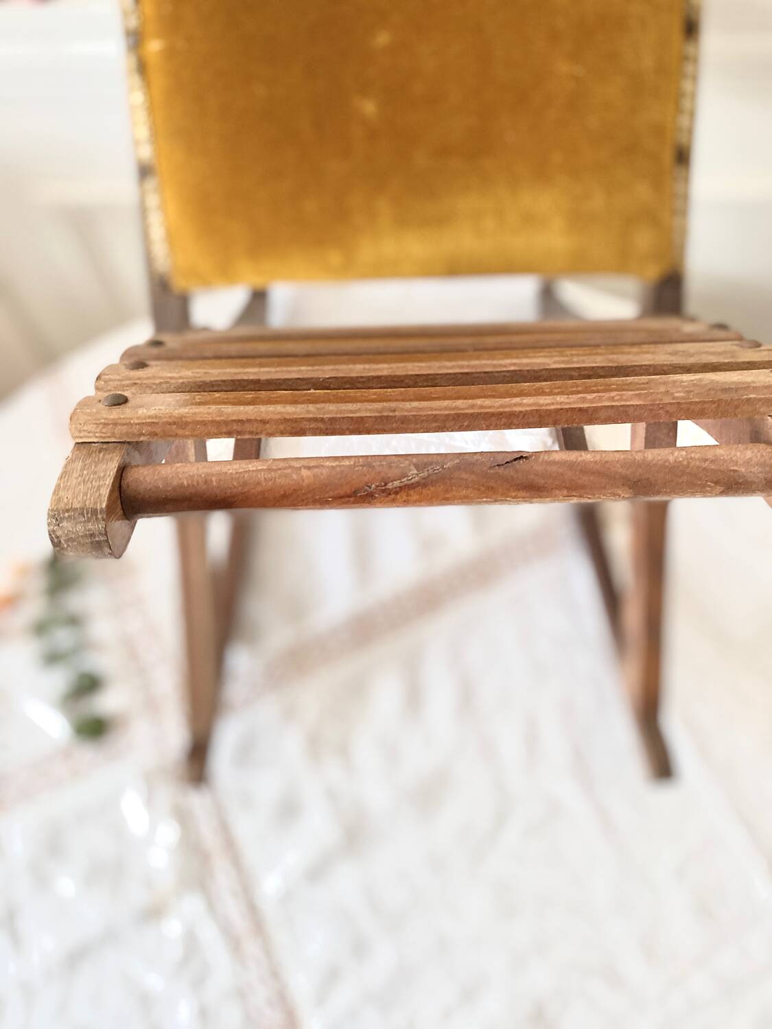 Old wooden rocking footrest with velvet fabric
