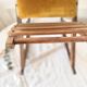 Old wooden rocking footrest with velvet fabric