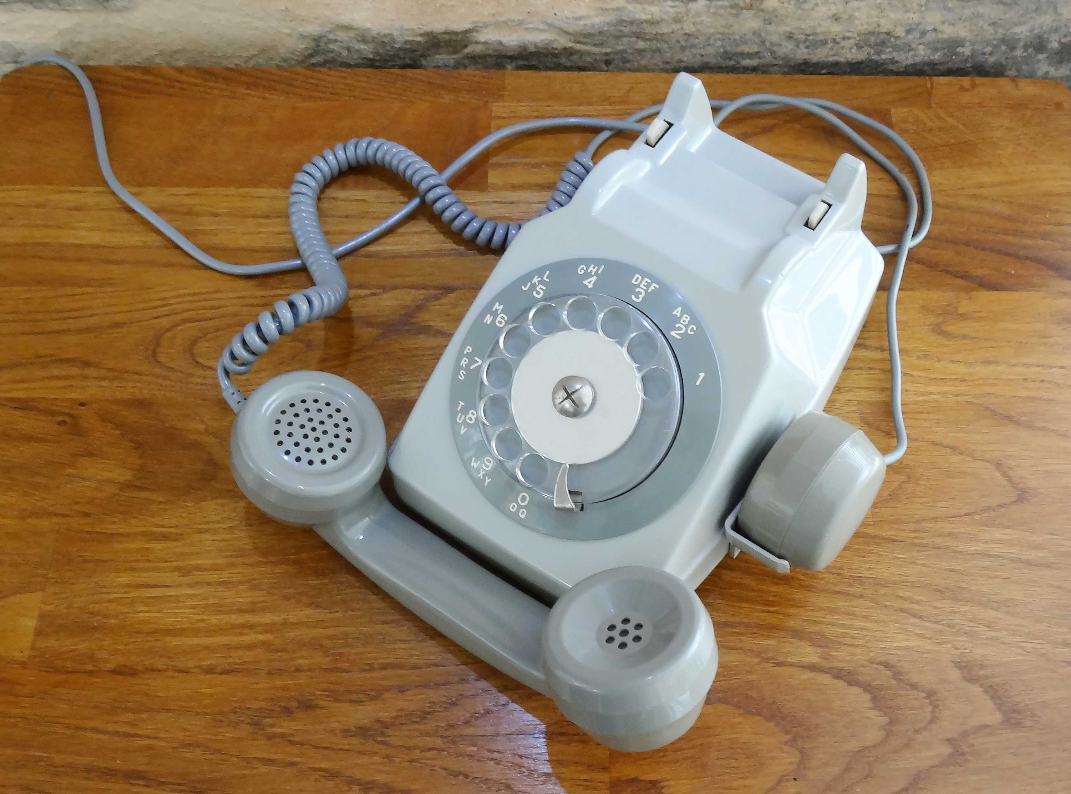 Grey vintage rotary dial phone with earpiece