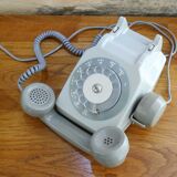 Grey vintage rotary dial phone with earpiece