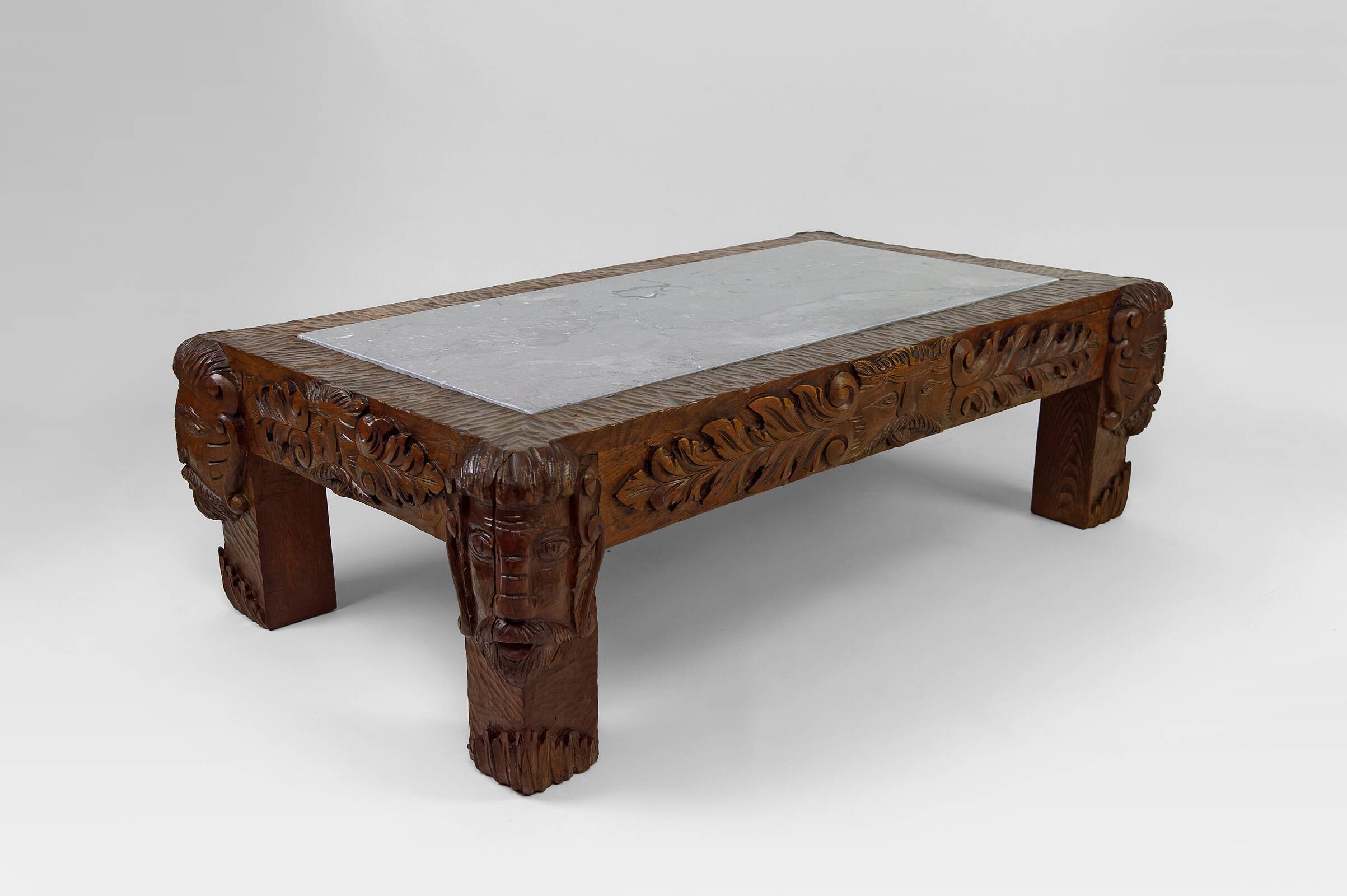 Solid oak coffee table carved with fauns and gray marble top, France, circa 1940