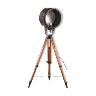 Old industrial spot on wooden tripod floor lamp