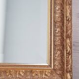 Mirror in gilded stucco wood and beveled glass