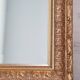 Miroir en bois stuc doré et verre biseauté